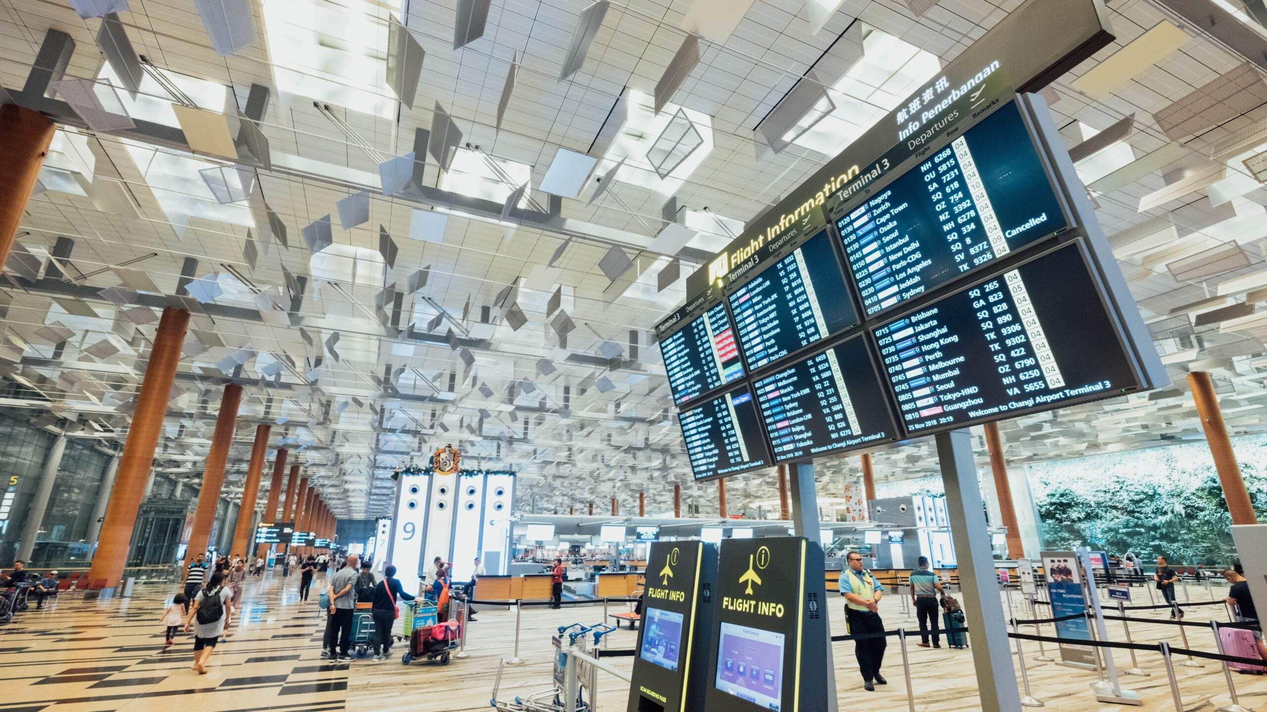 Travellers inside CDG airport terminal between flights